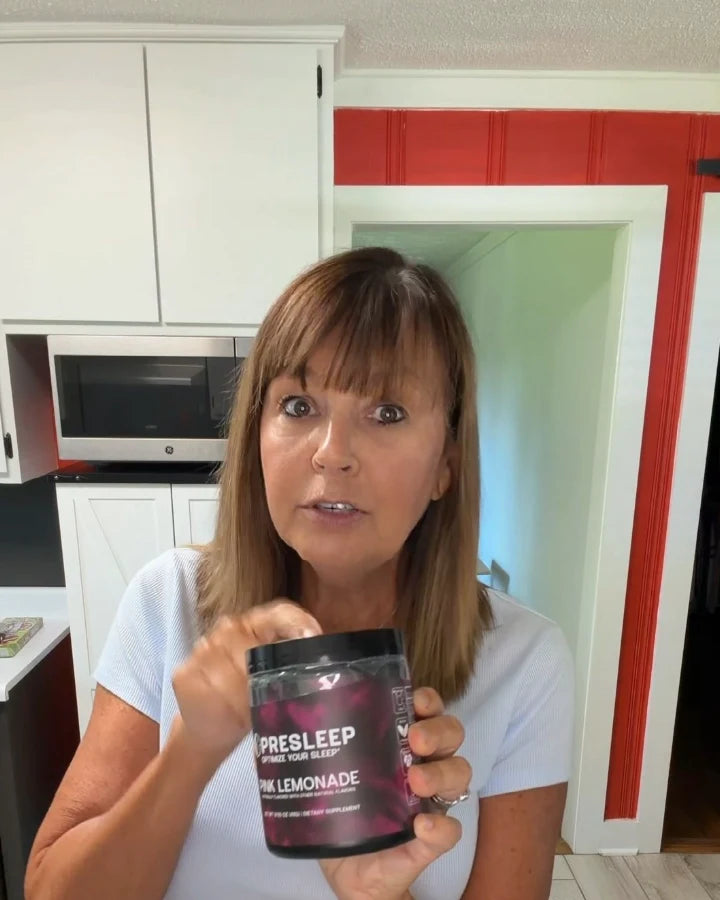 PreSleep customer holding her jar of Pink Lemonade in her kitchen