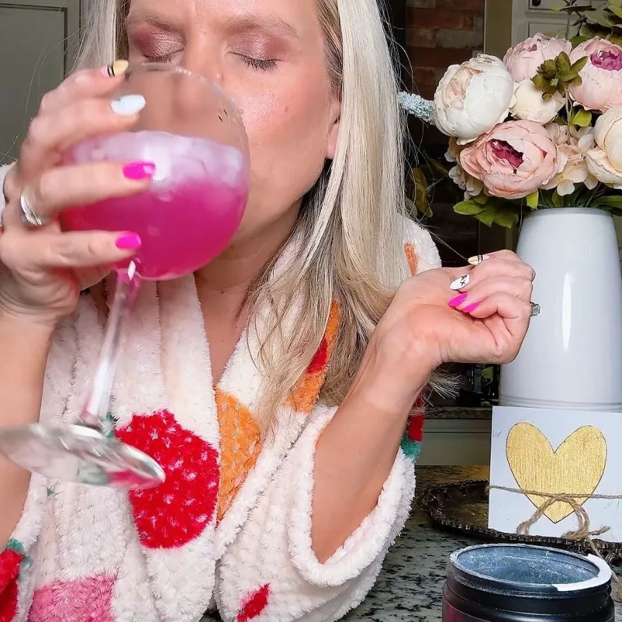 PreSleep customer in her robe, eyes closed, sipping Pink Lemonade